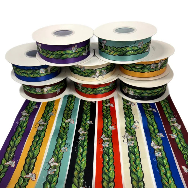Collection of ribbon spools with colorful patterns on a white background